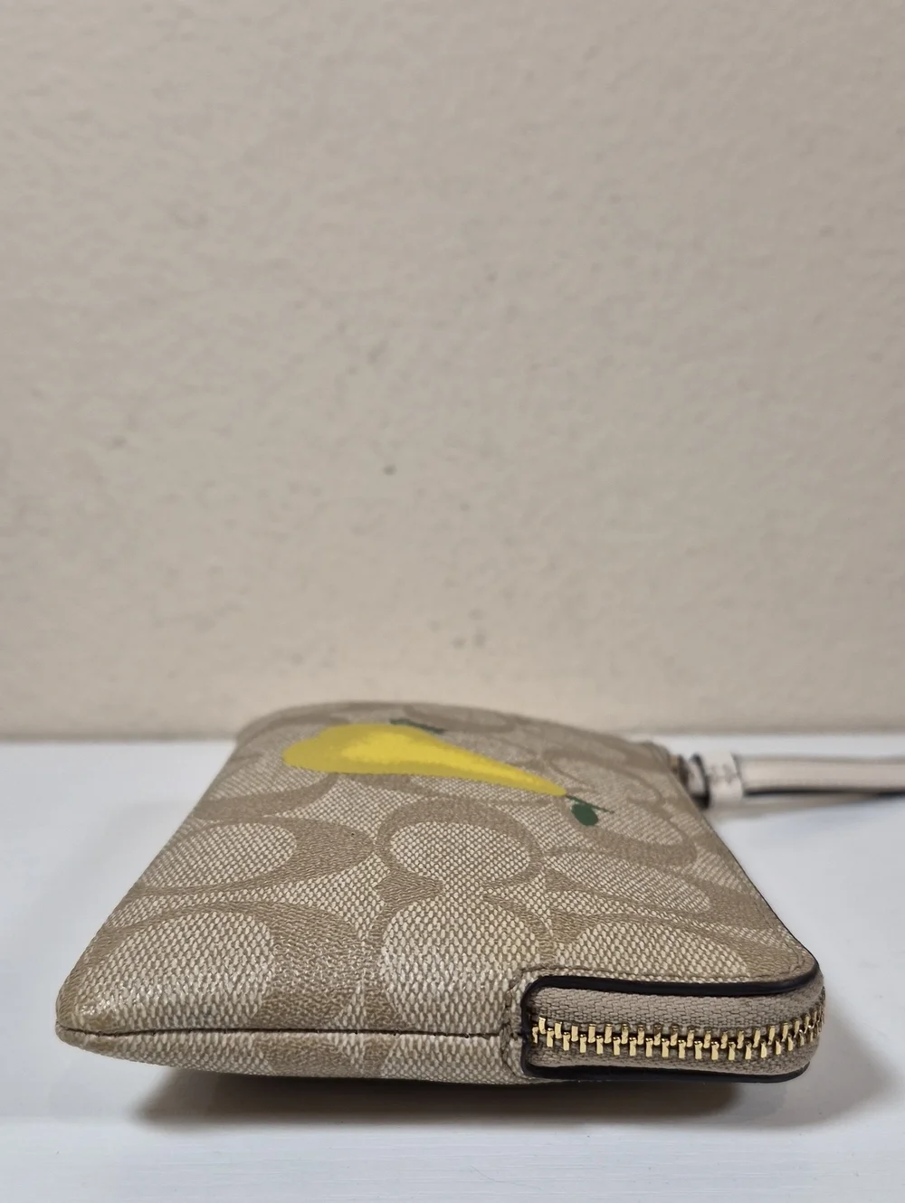 Coach Corner Zip Wristlet In Signature Canvas With Pear